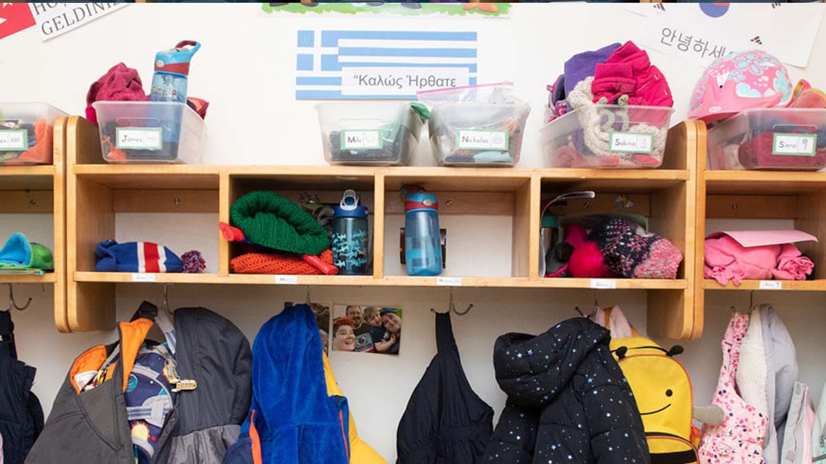 Preschool classroom coat closet with cubbies and bins.