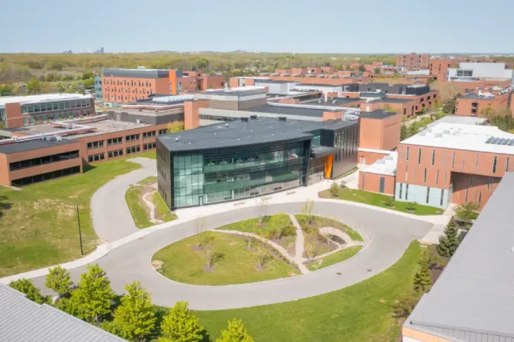 Arial shot of campus with a glass building