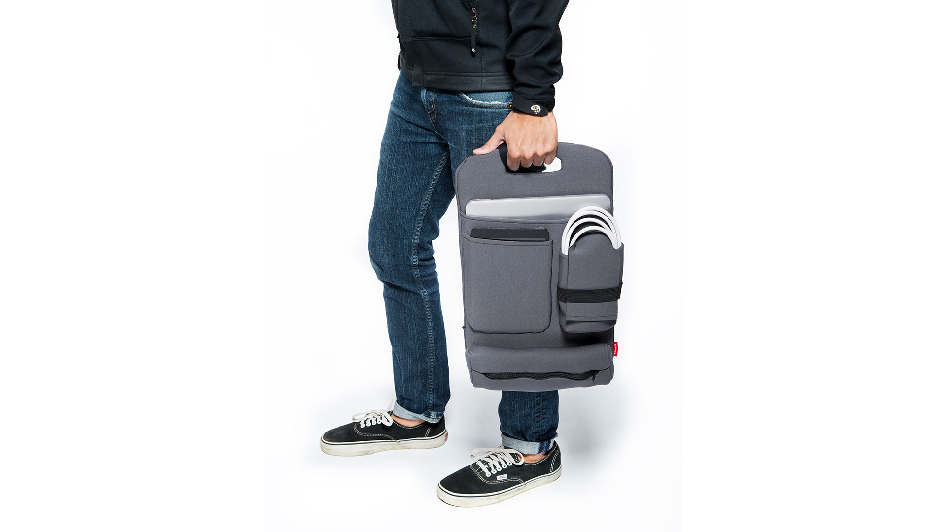 Someone holding grey backpack organizer at their side by top handle