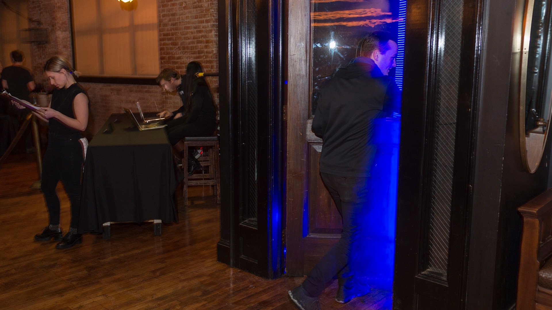 Someone walking through doorway entrance from inside showing deep blue light