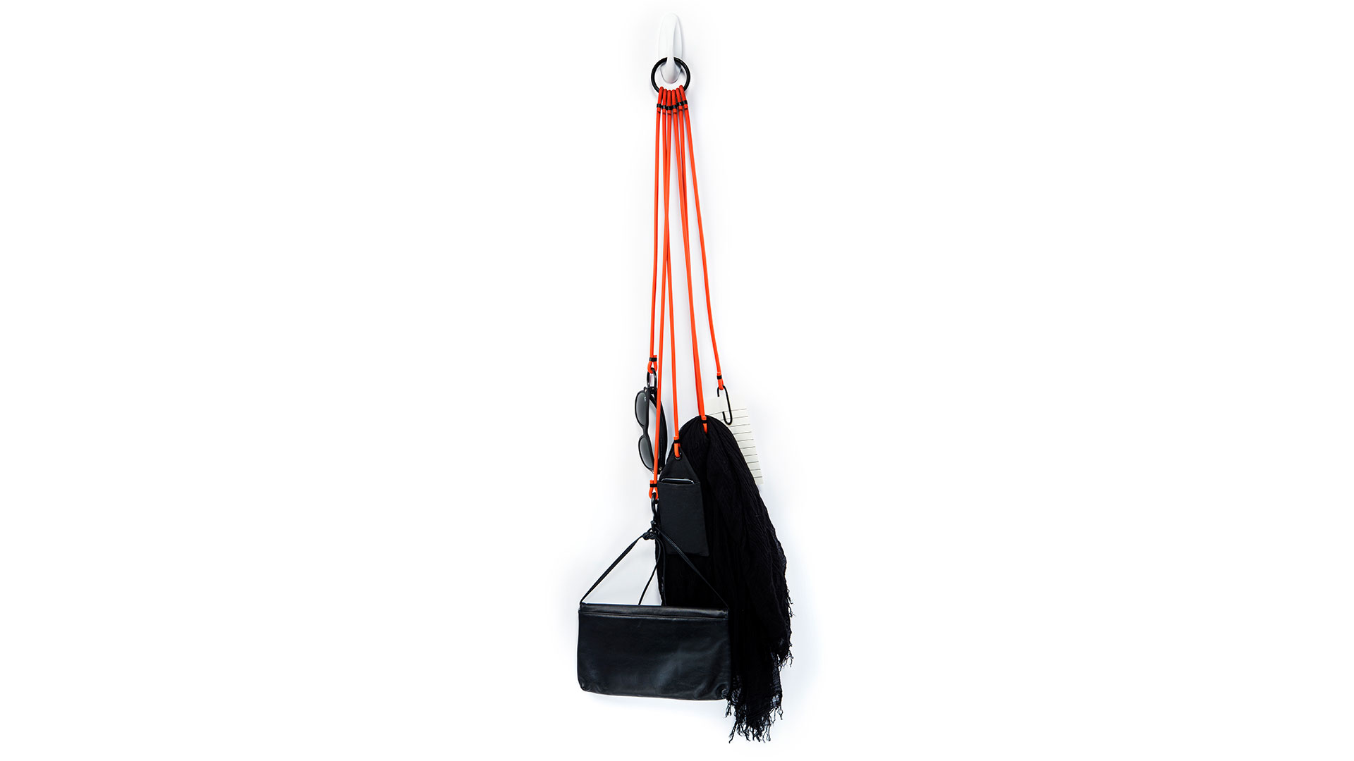 Full length view of cords on hook with assorted accessories attached including purse and scarf
