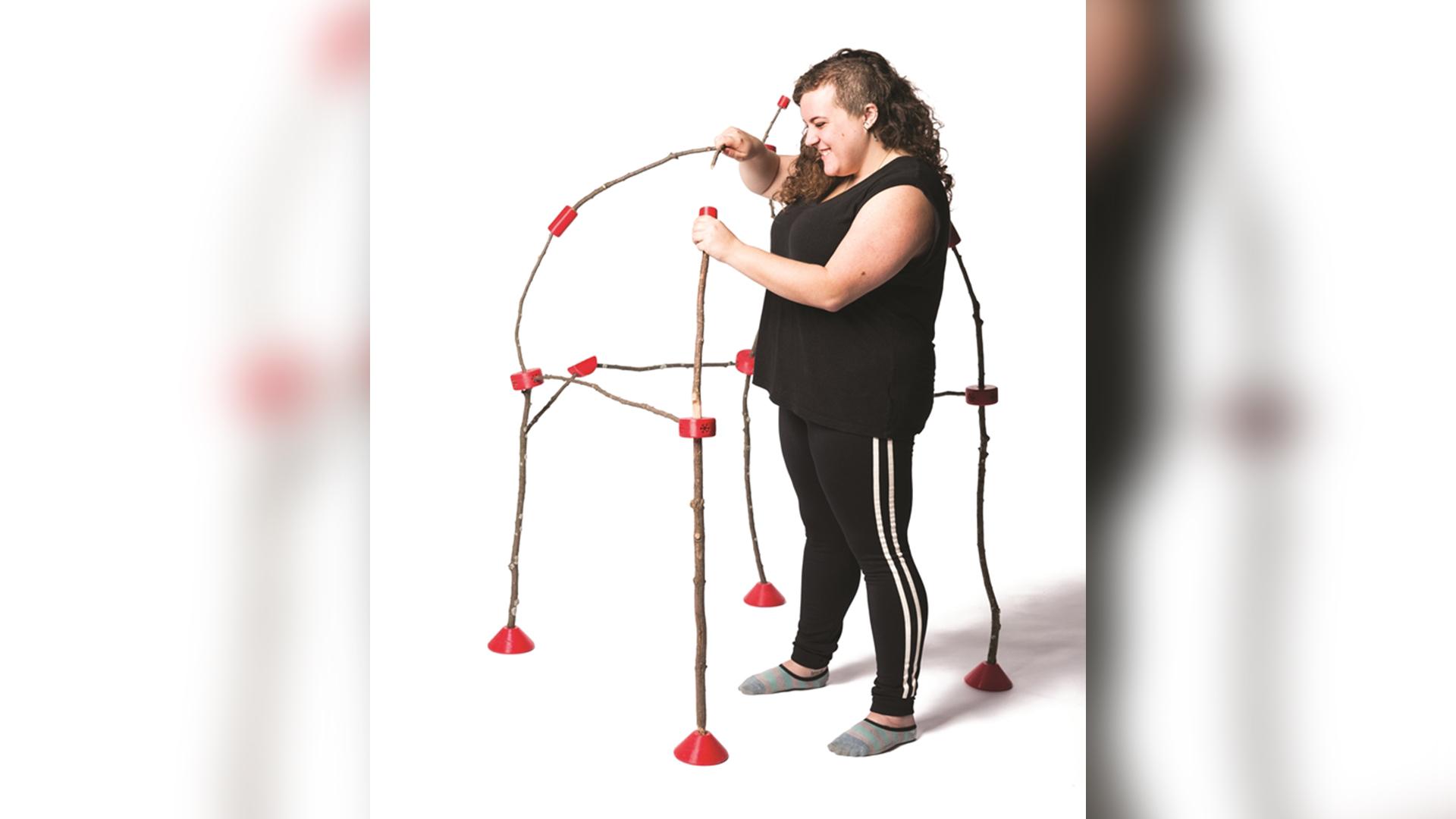 Someone assembling Stick Connectors into dome structure