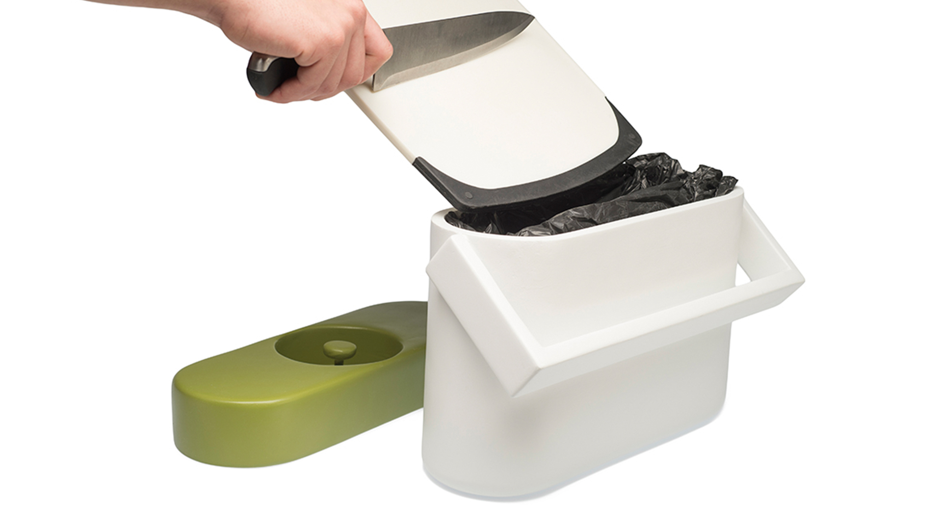 Green lid removed and next to pail as someone holds cutting board and knife above opened pail
