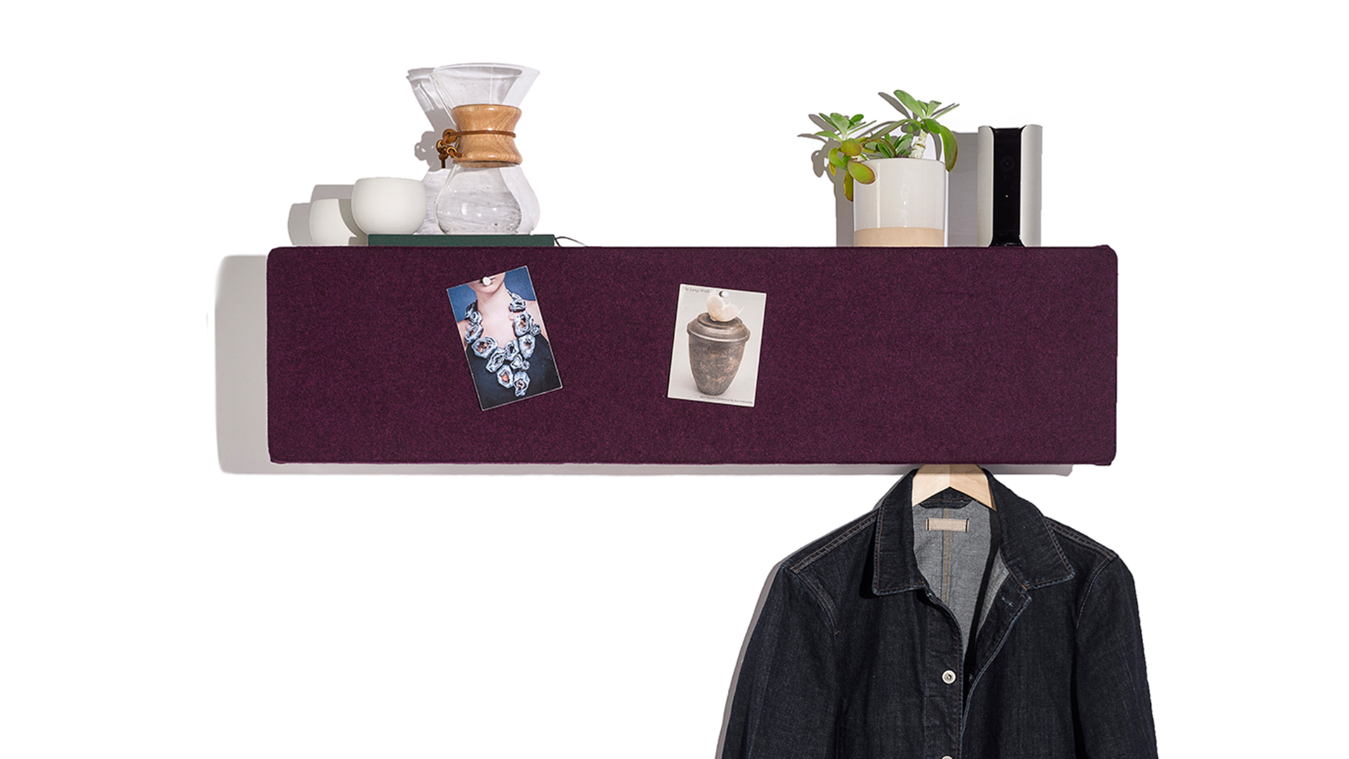 Long rectangular Pop Shelf with purple front, various objects on top, pictures pinned to front, and jacket on hanger hanging from behind front