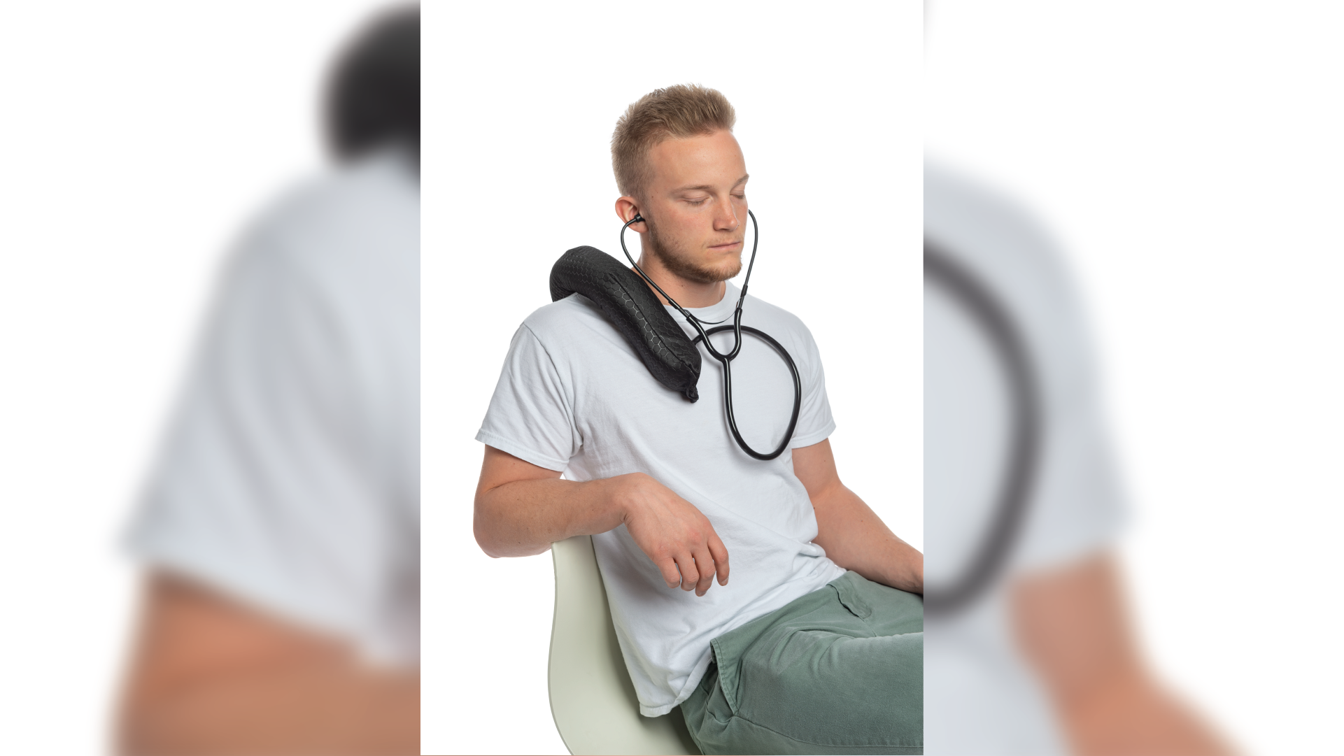 Person sit on a chair listening their heartbeats through the black wearable bag linked to the stethoscope.