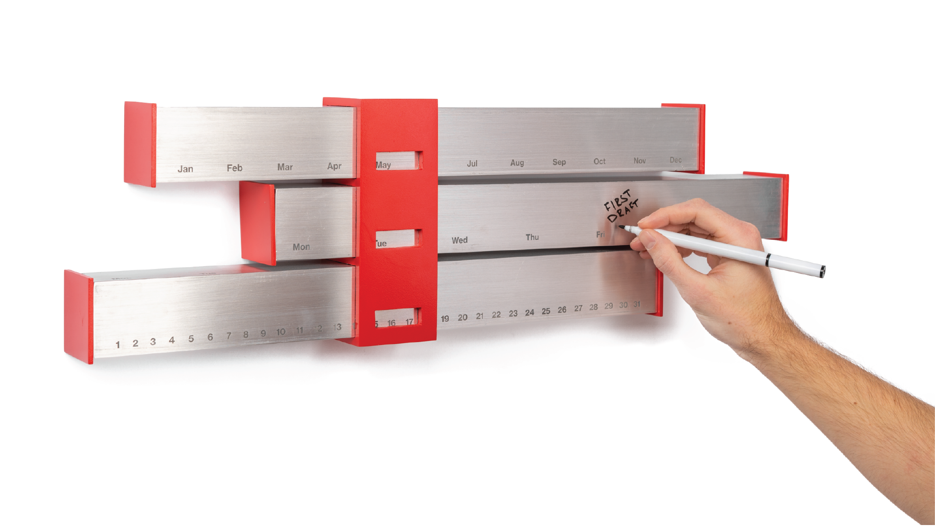 Hand writing "first draft" on the aluminum tube placed on the middle.