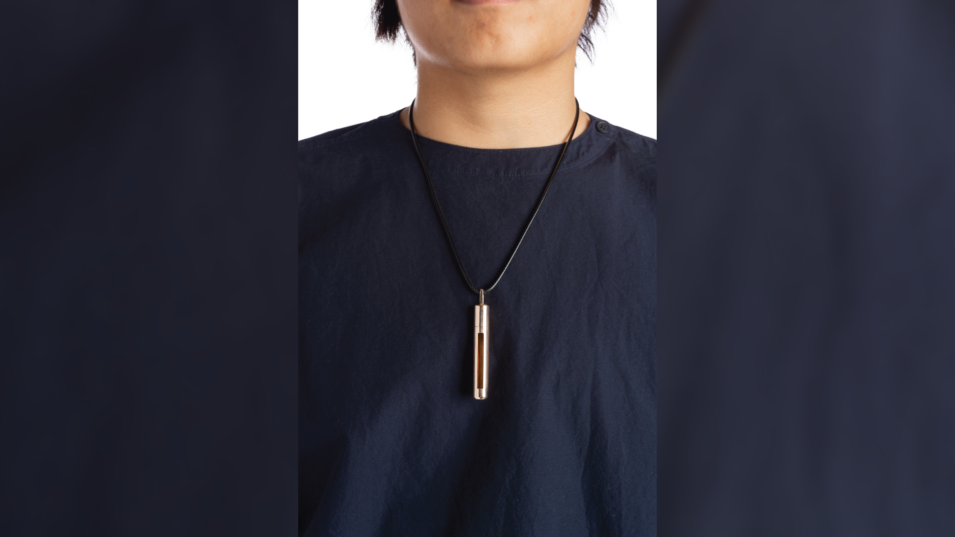 Closer shot of the person using the necklace.