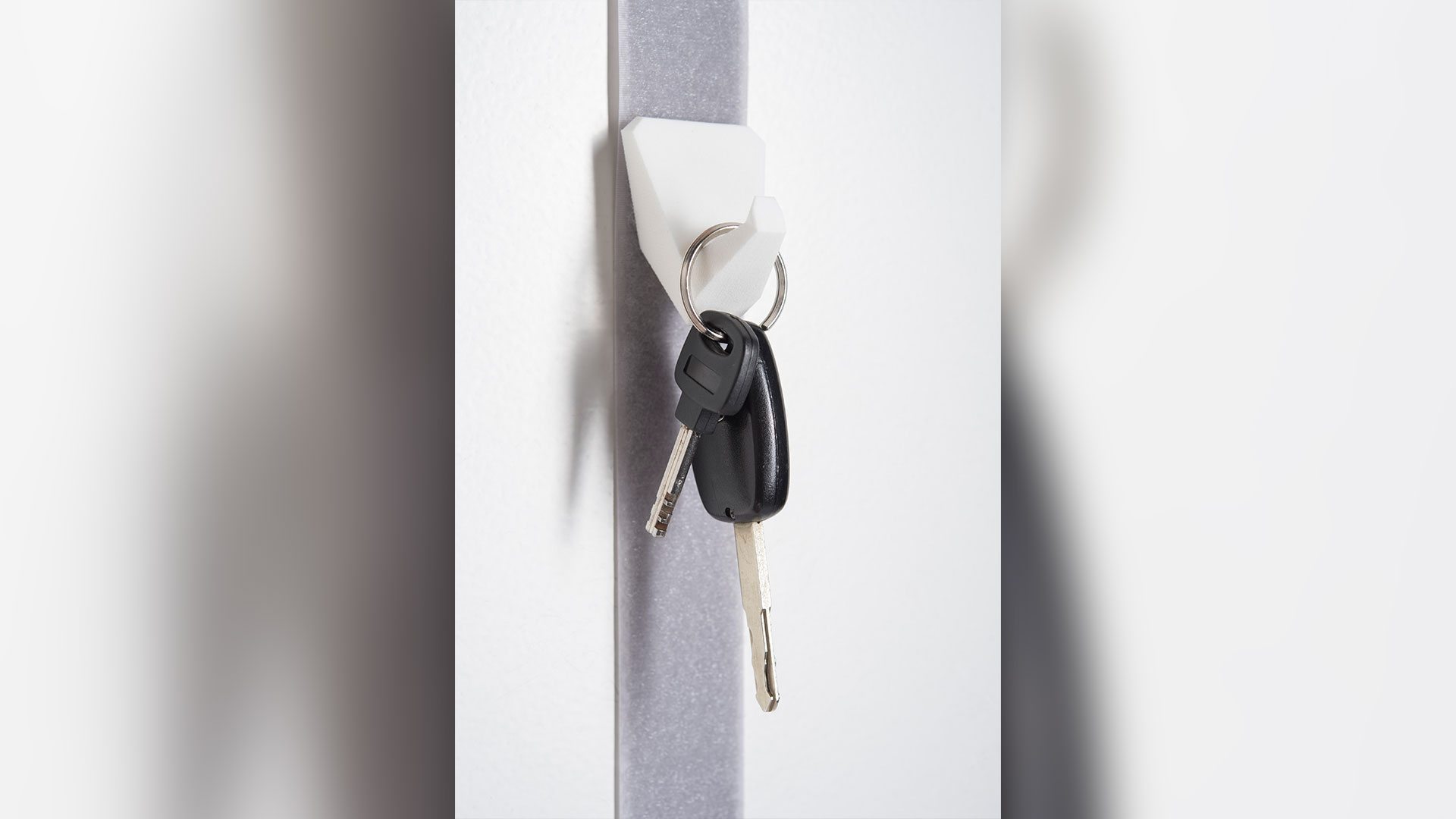 close up of door light grey/purple belt with white hook with car keys hanging 