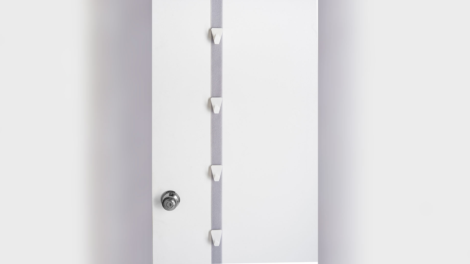 light grey/purple door belt hanging vertically down door, 4 small white hooks on belt, door know at bottom left of image 