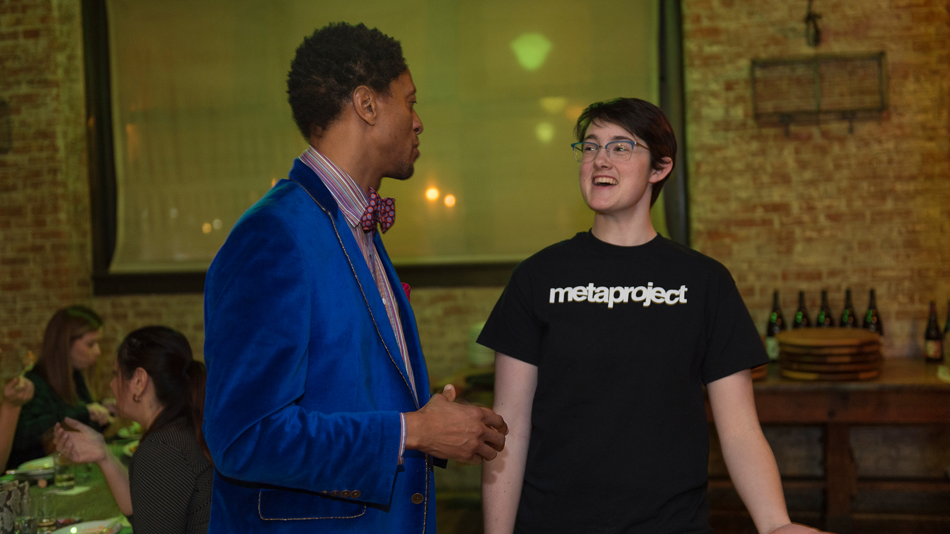 Student talking to guest at event