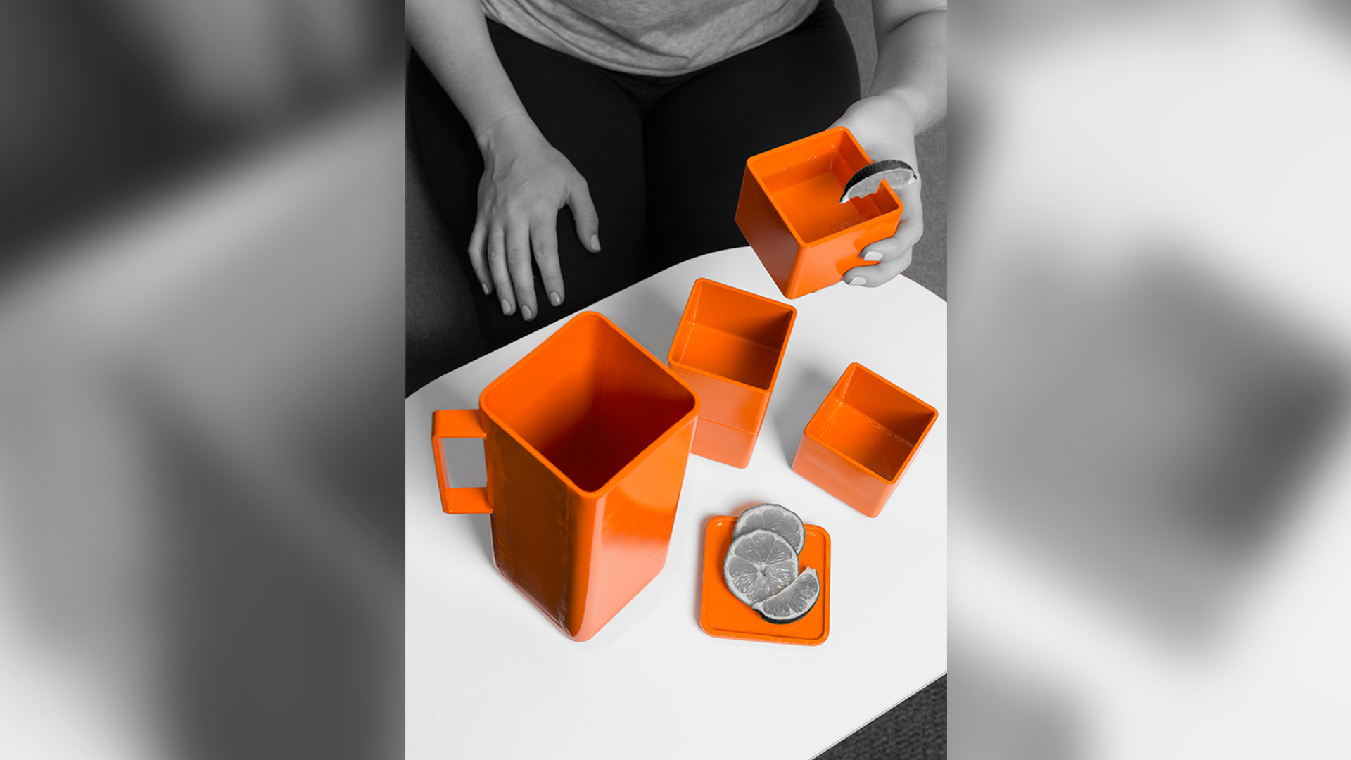 Carafe with lid off with four cups on table