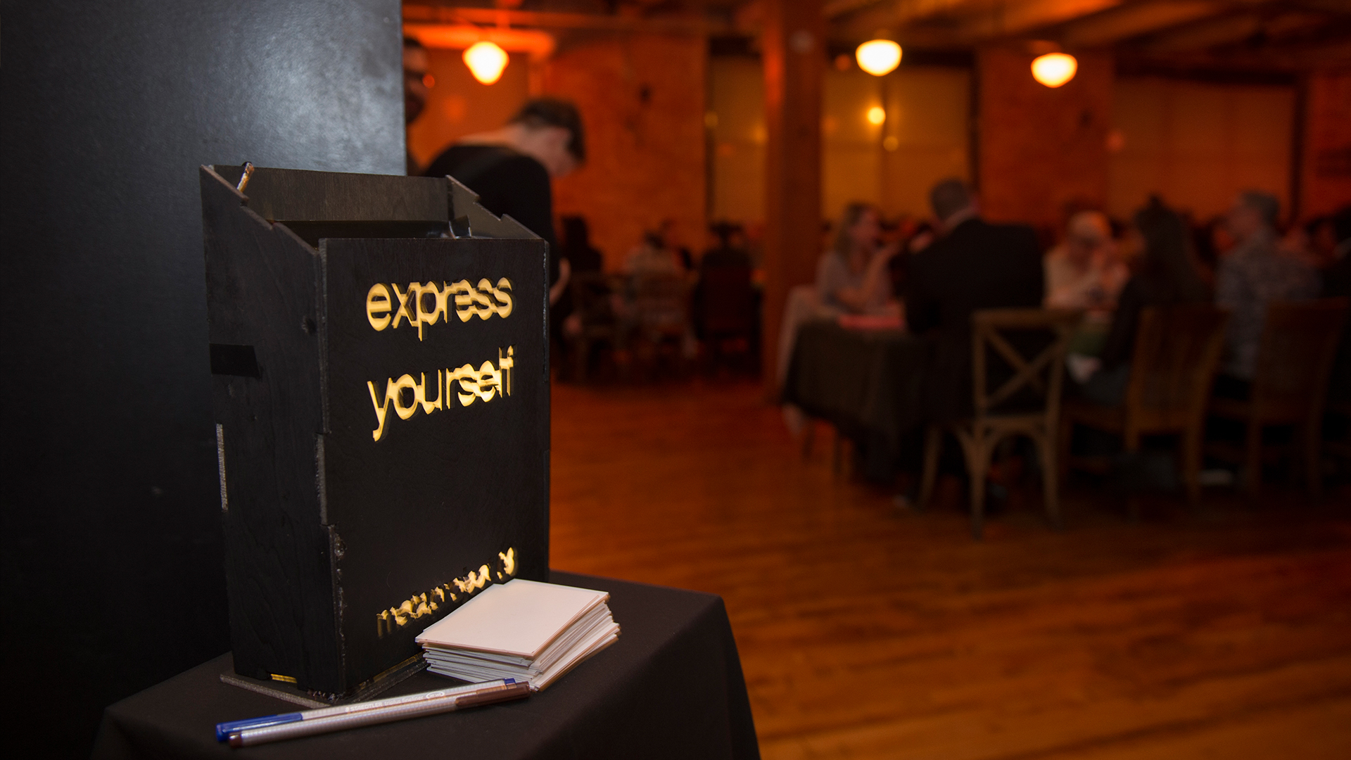 Feedback sign on stand shown in front of dining space