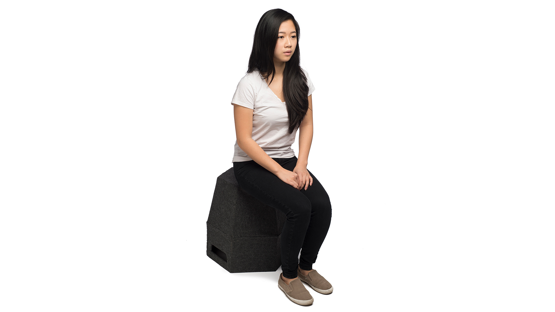 Someone sitting on Hexagon shaped container