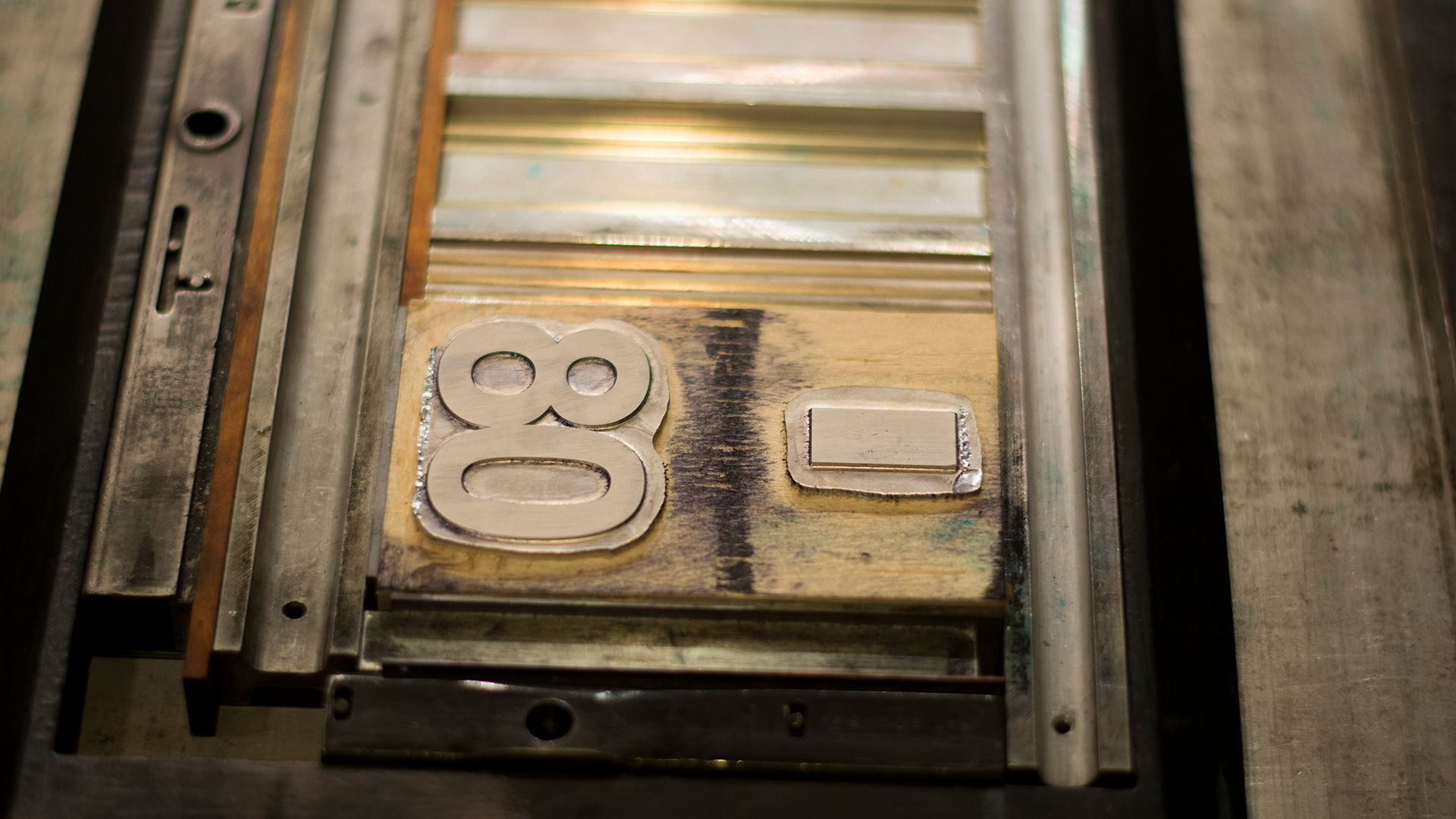 Close up of unuse metal stamp of 08 in press