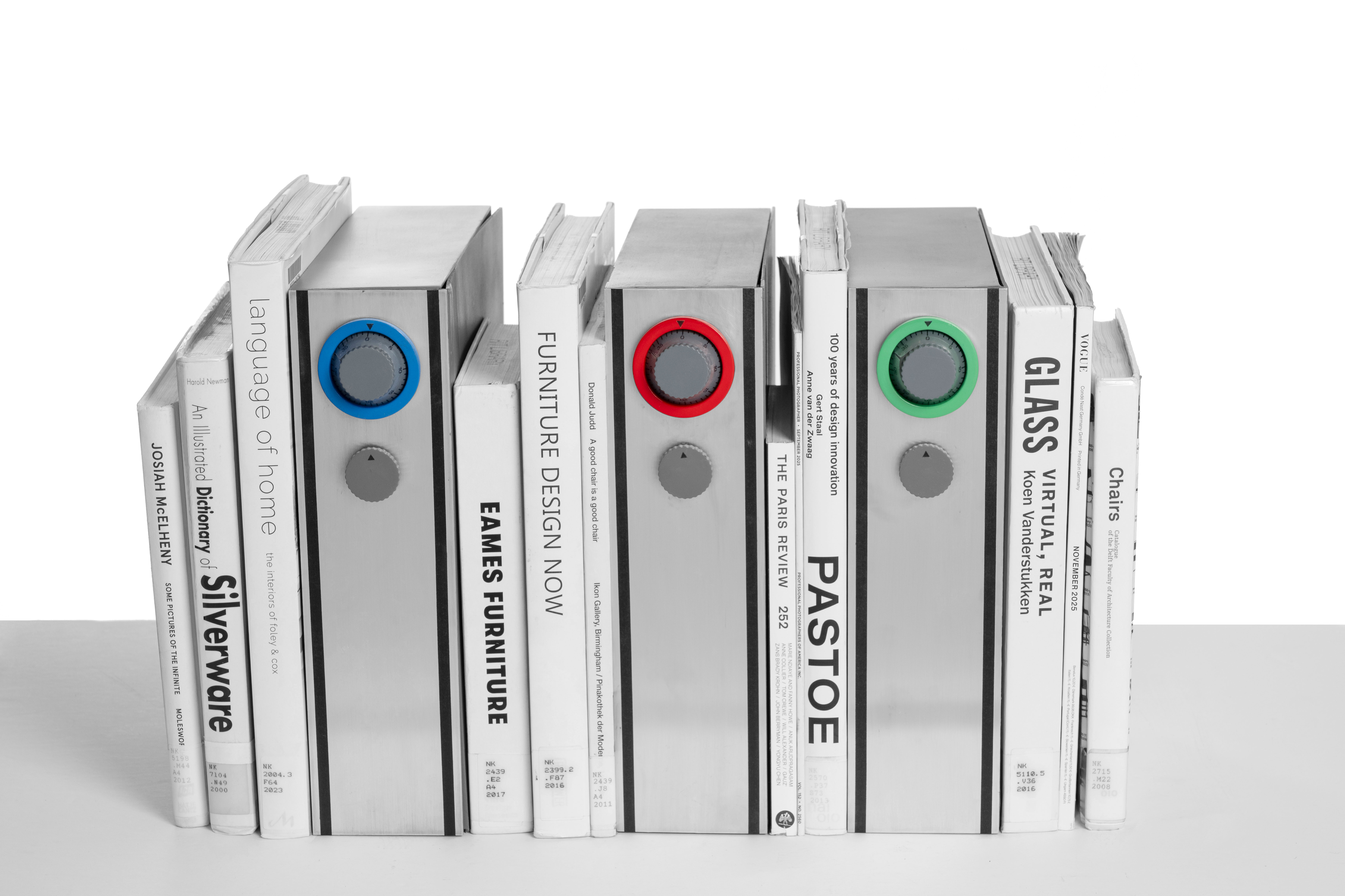 Photo of three Capsule models placed within a row of books.