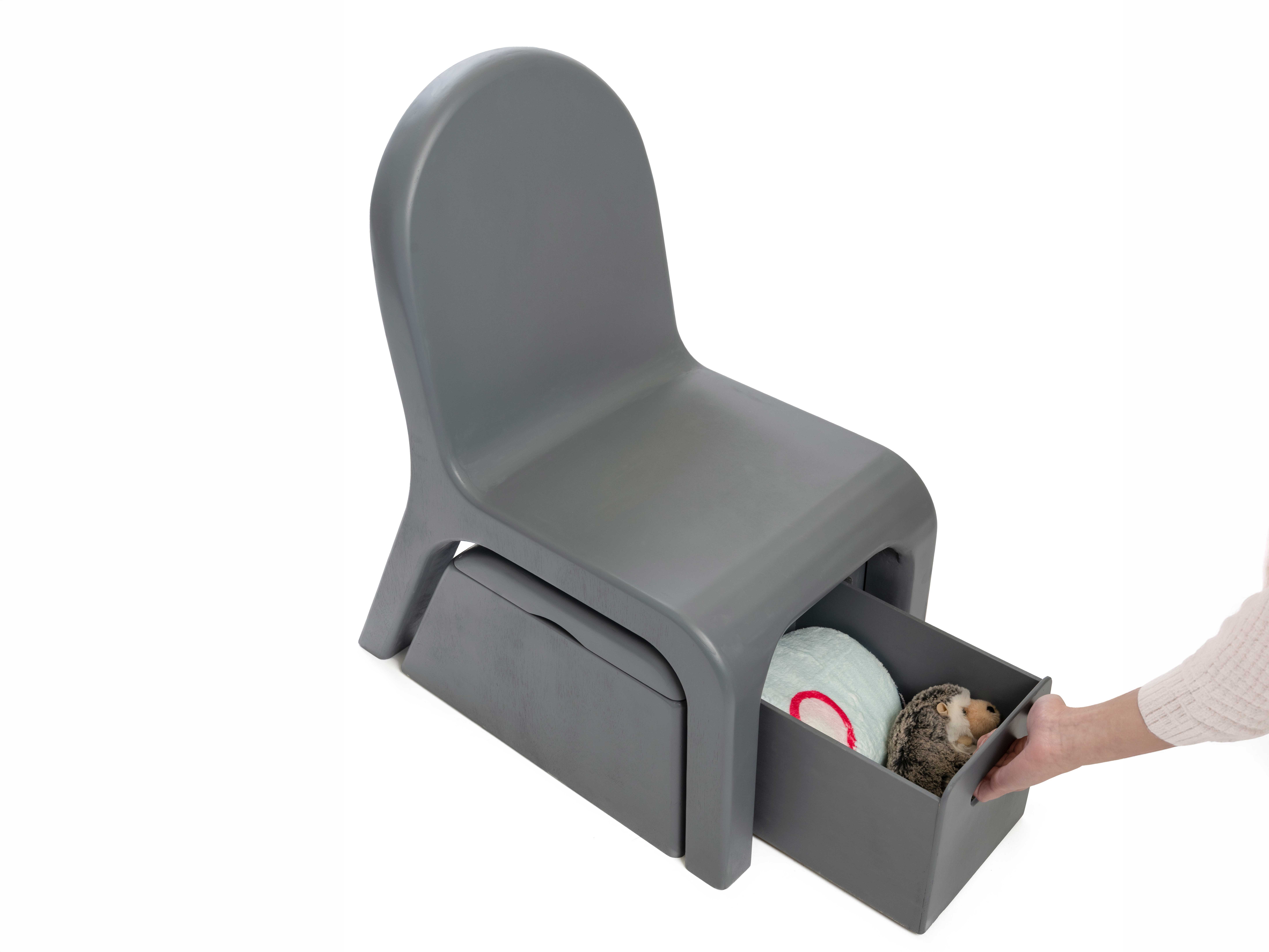 Front top perspective view of the Care Chair model with a hand pulling open the drawer. 