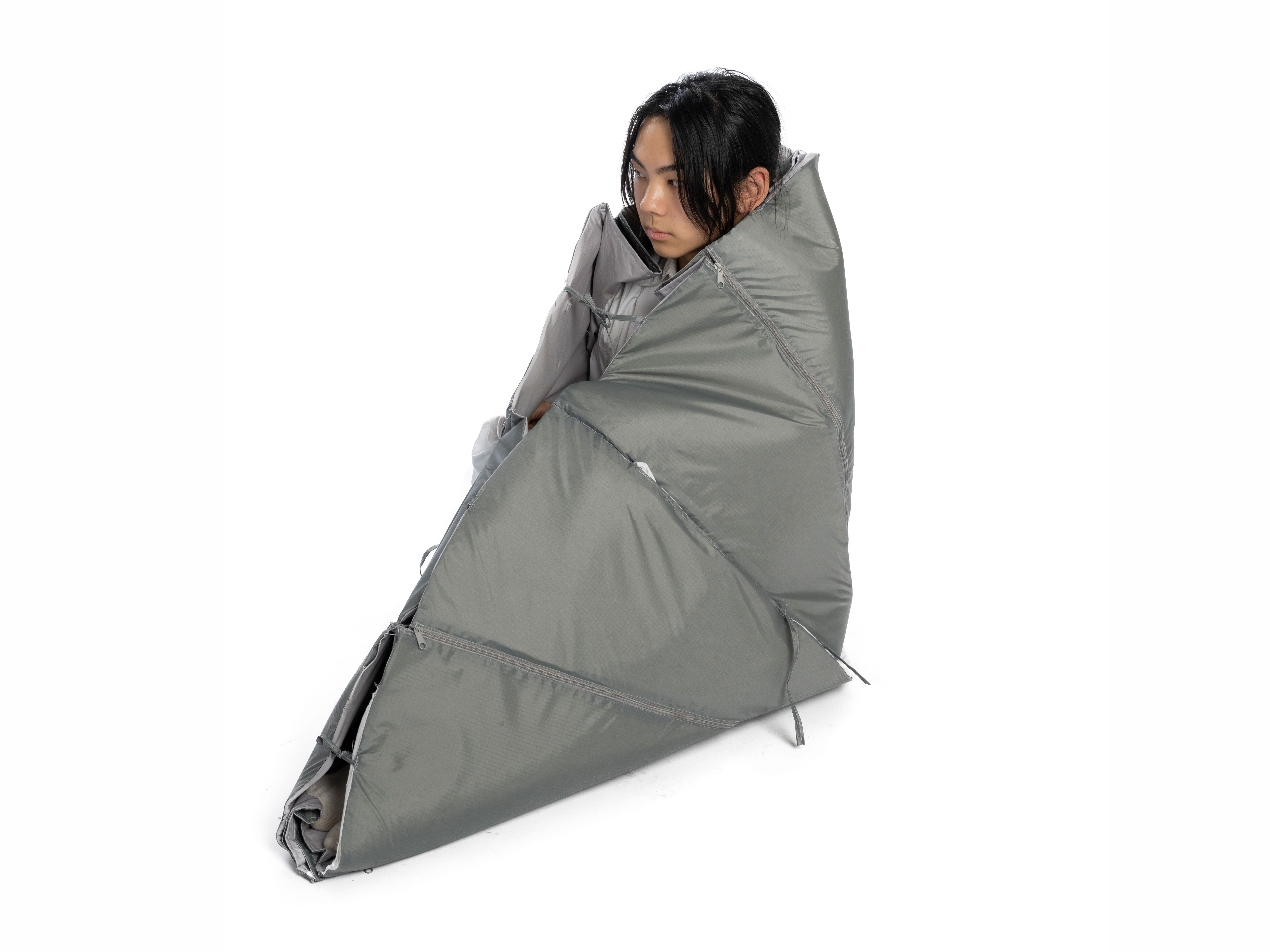 Photo of a seated women wrapped up in the Cloak model.