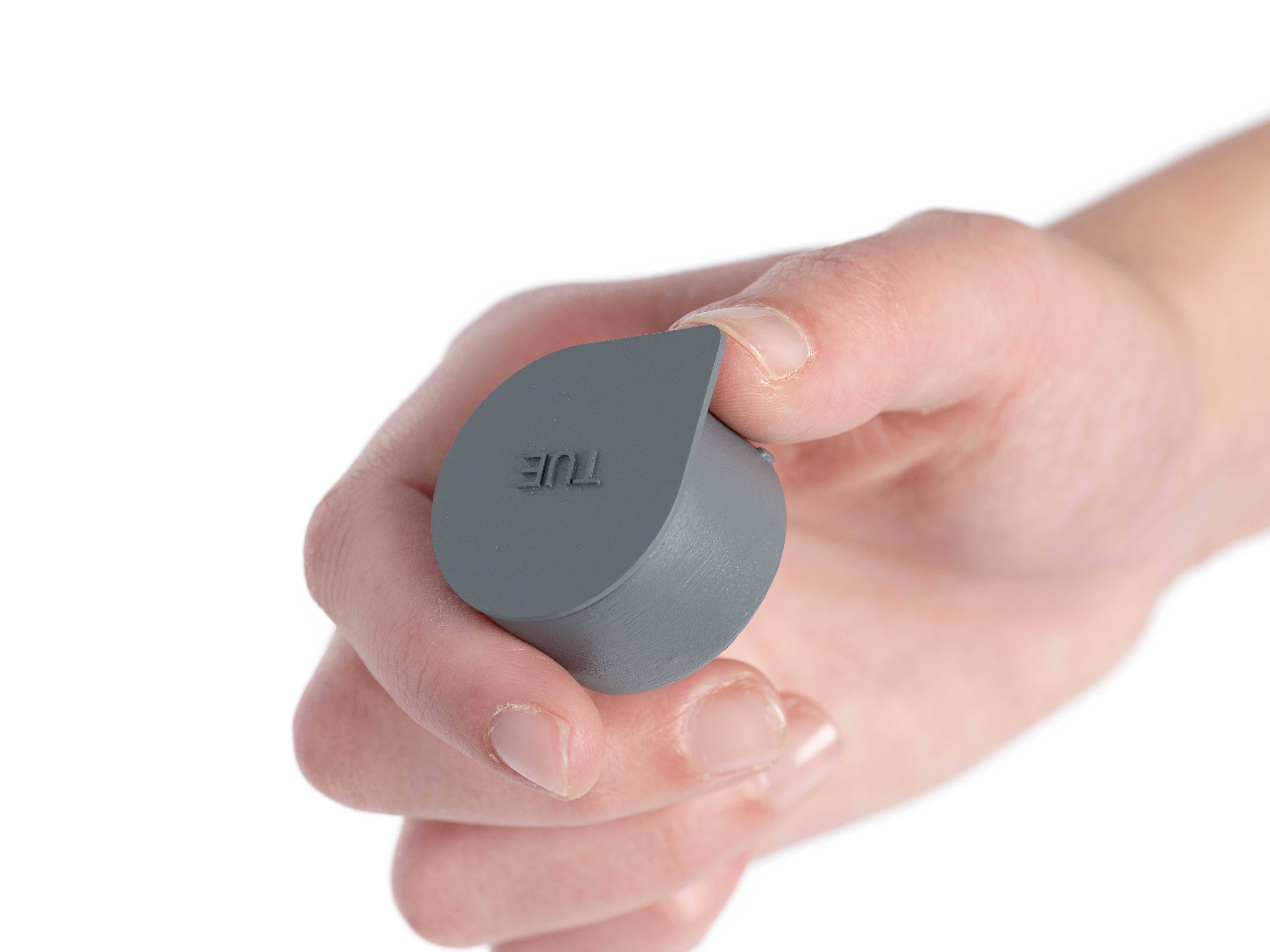 Photo of a hand holding the Tuesday pill container from the Sorted Medicine Cabinet model.