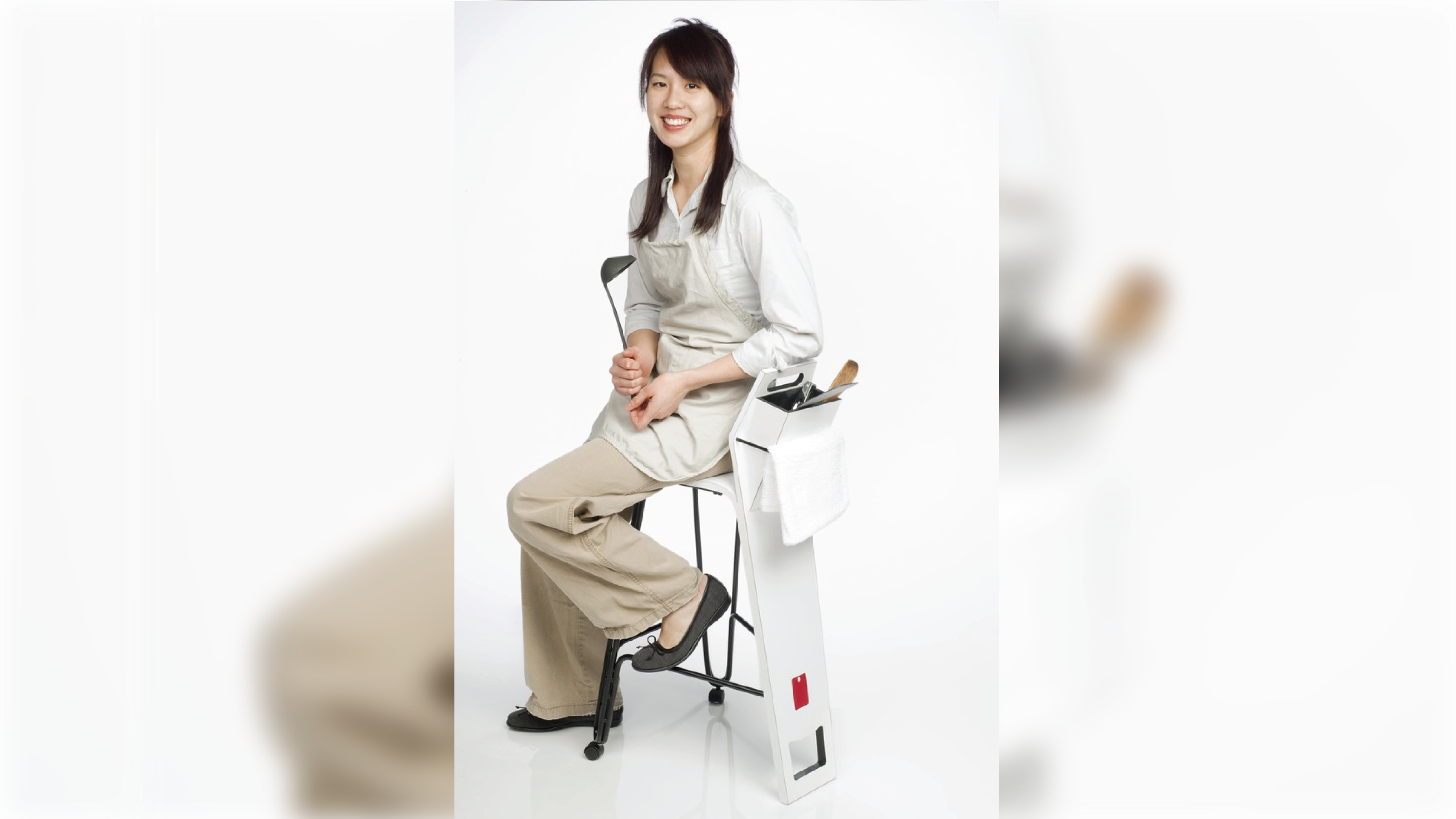Student sitting at a stool that holds kitchenware.