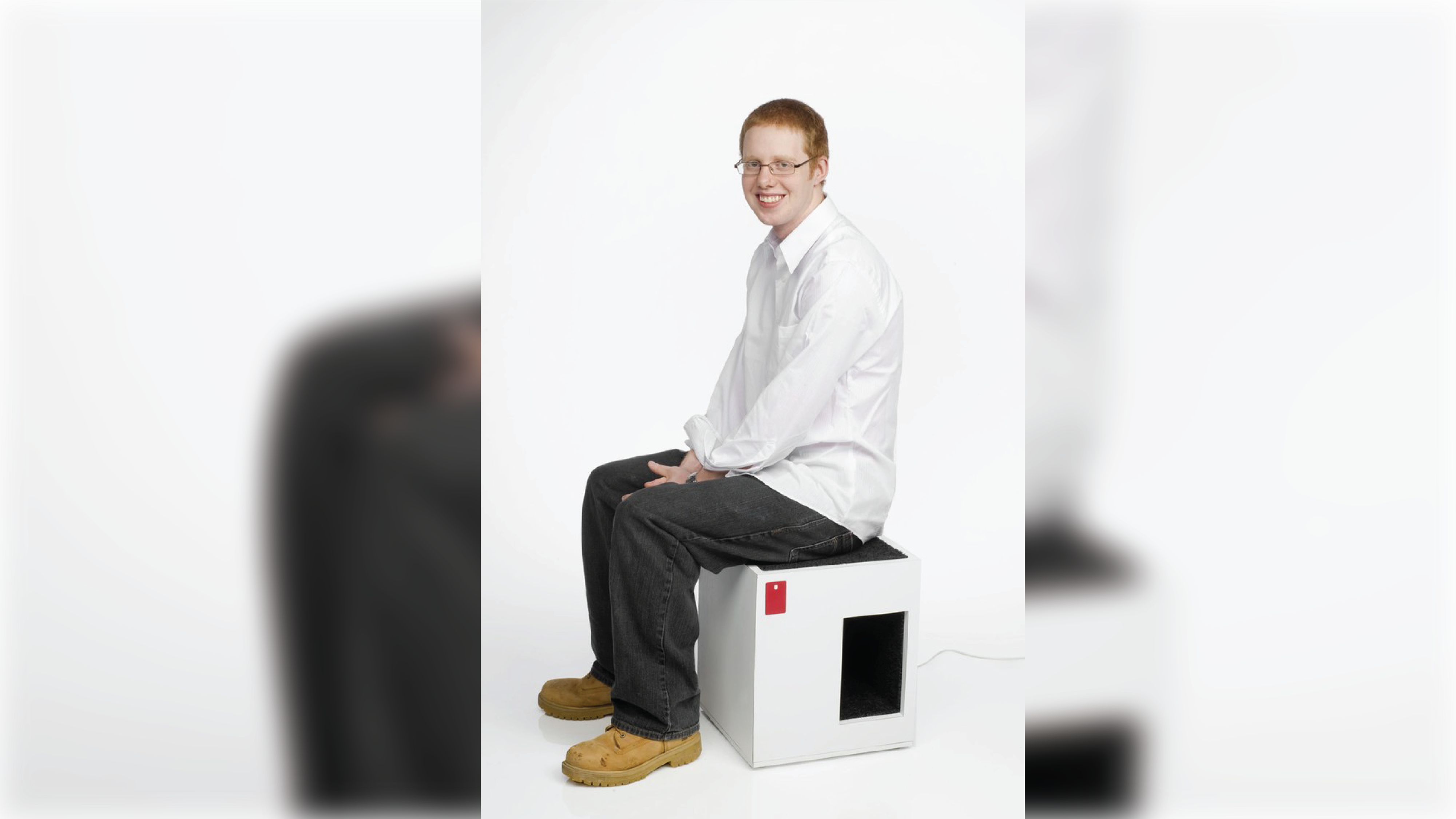 Student seating at a stool with a spot for pets on the bottom.