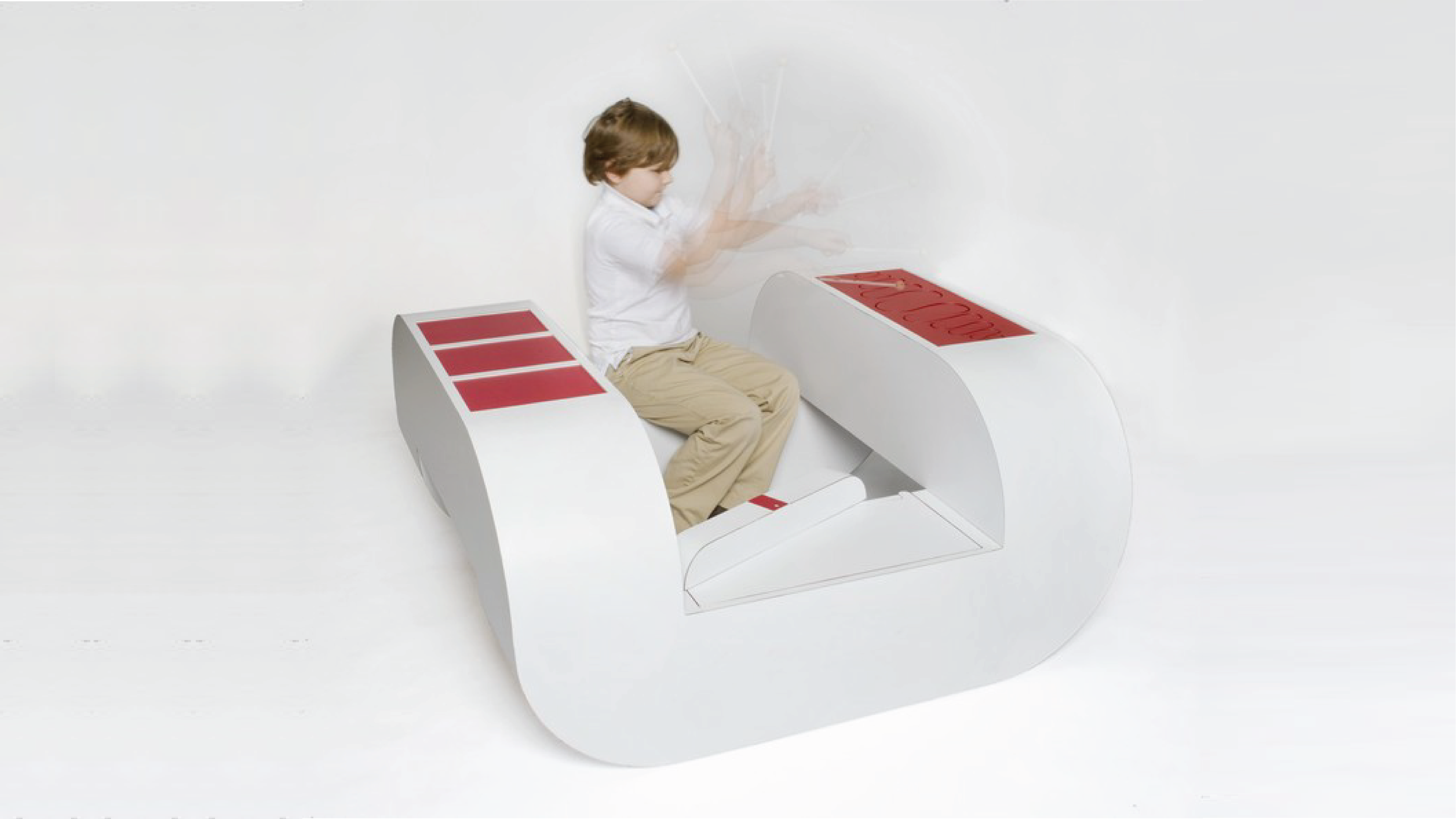 Children playing drums on the U-shape chair.