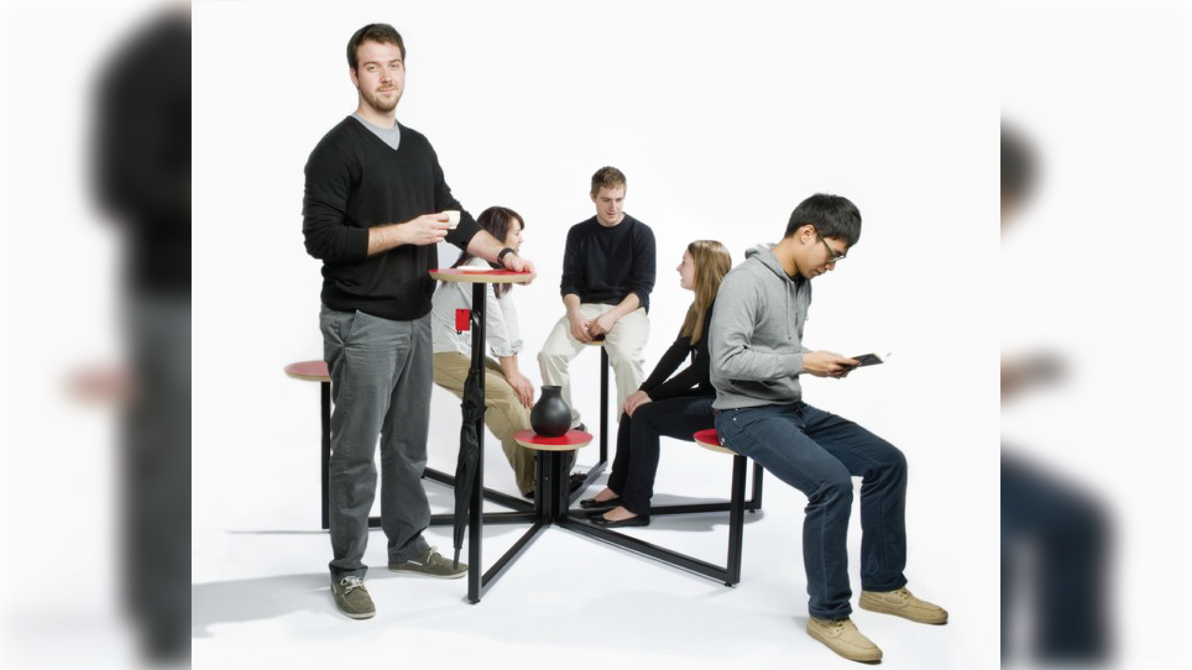 People seating and interacting with a furniture piece.