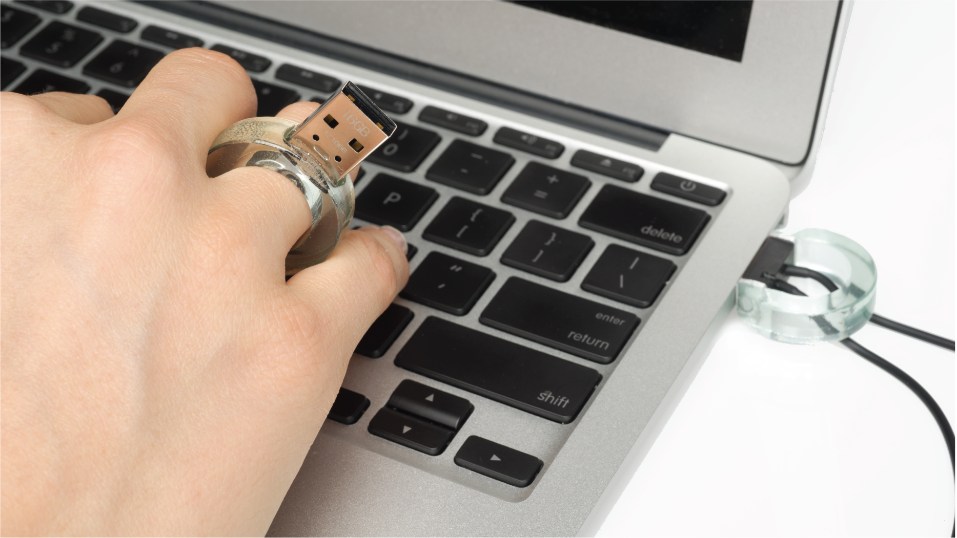 Hand wearing the glass Ring with a USB port.