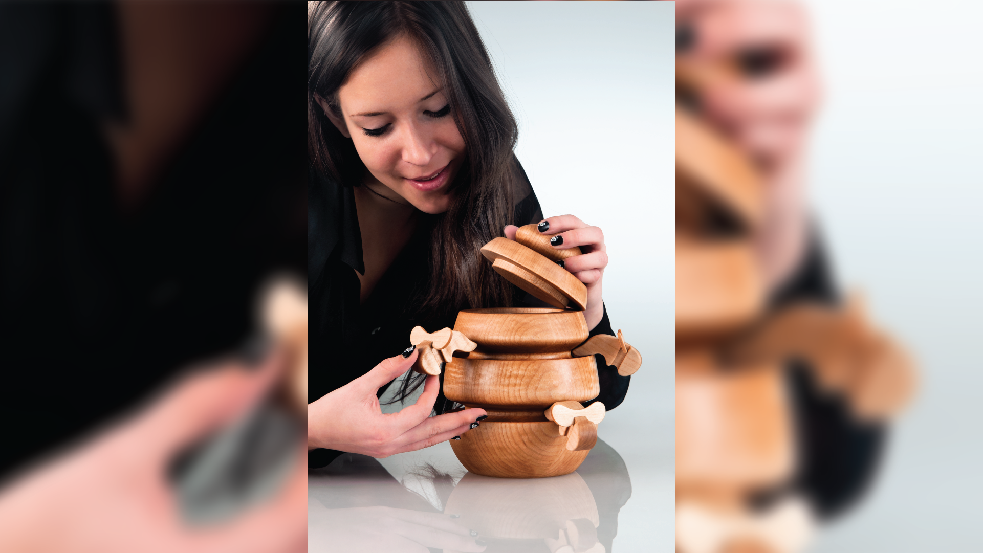 Person interacting with the wooden vessel, opening the lid and hanging a bees on the outside.