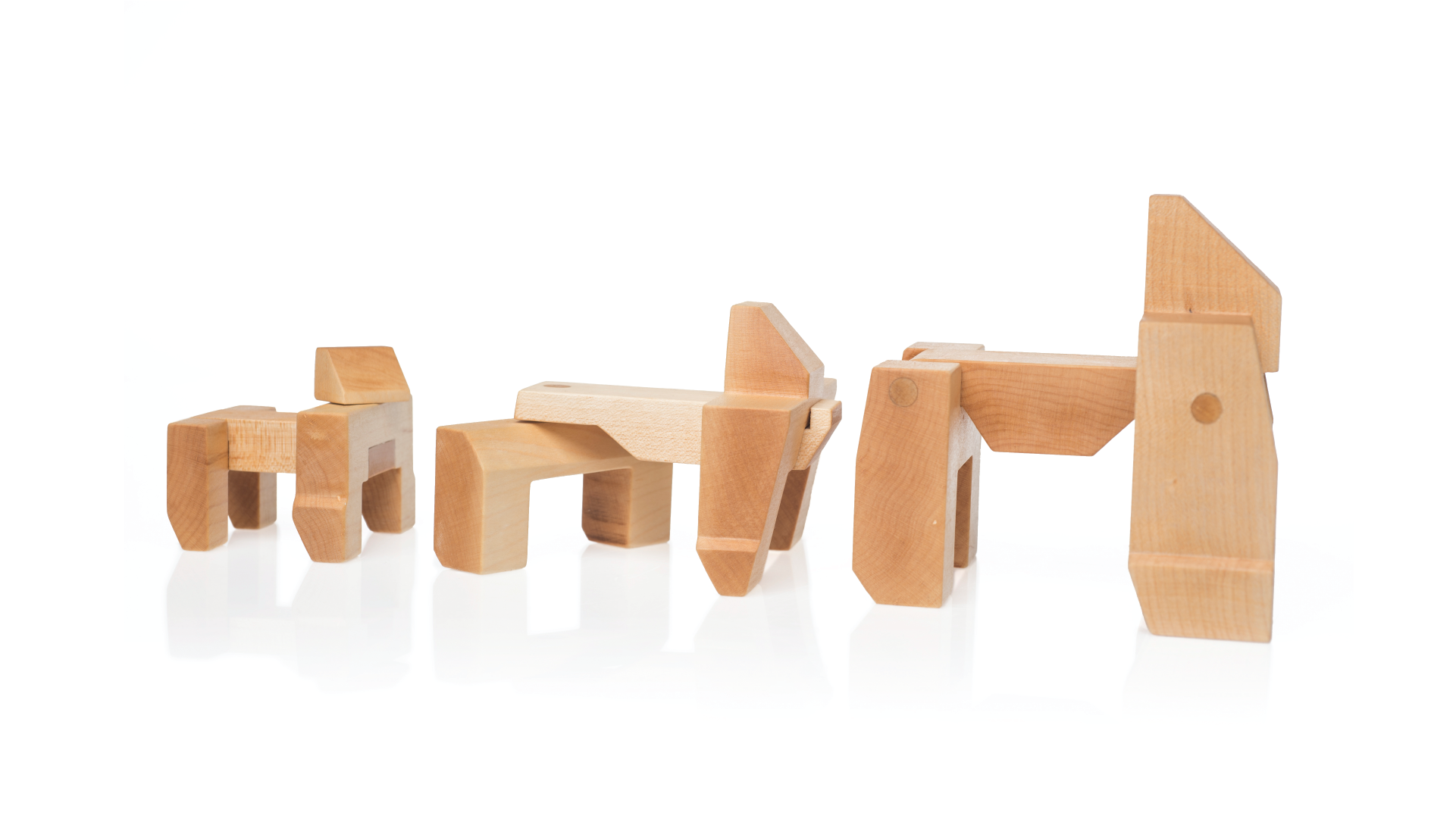 Wooden blocks stacked together creating three different sizes and forms of gorillas.