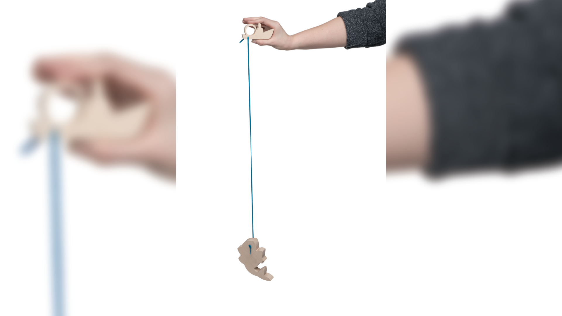 Hand holding the pendant through a string.