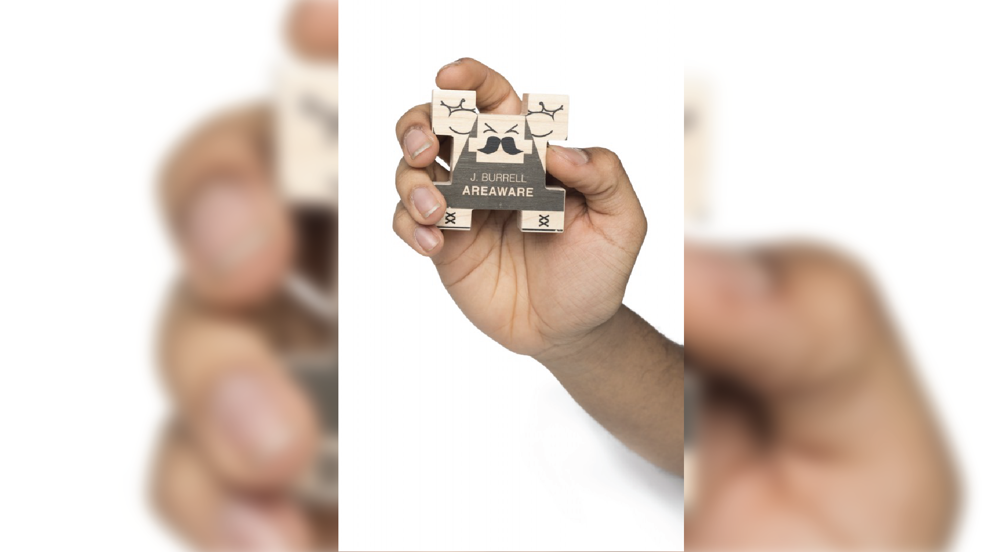 Hand holding one wooden building block men.