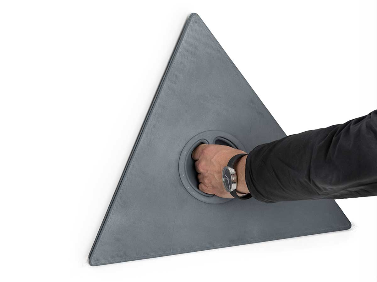 Photo of a hand holding the handle of the Corner Triad Box model when closed.