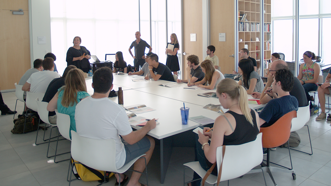 Students sitting around the table at the Vignelli Center with faculty and the industry partner.