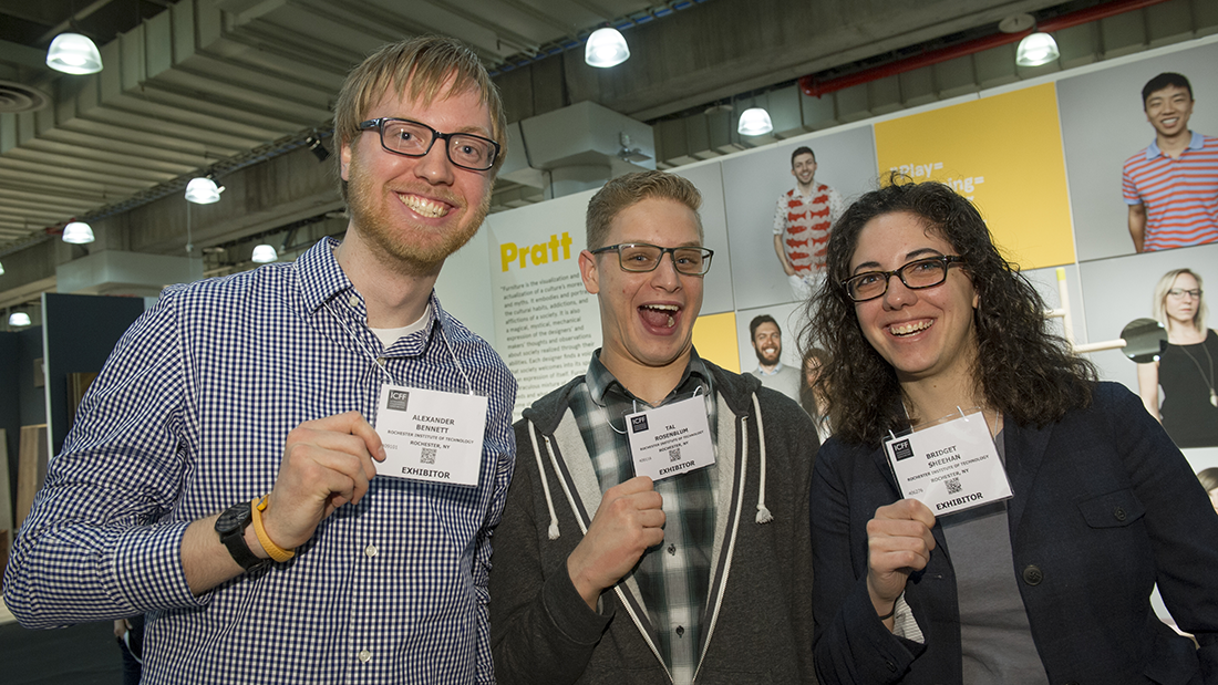Three students showing their exhibitor badge at ICFF.