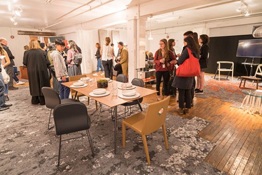 a group of people at a celebration with a dining table.