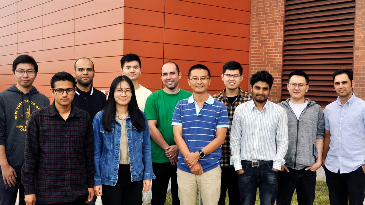 a group of people poses for a photo outdoors.