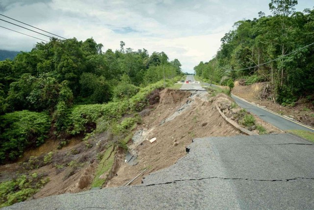 a road is shown after being taken out by a landslide.