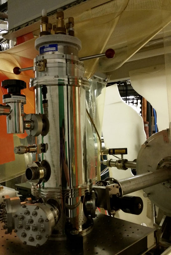 In-situ measurement system for defect spectroscopy. Shown is a 6-sample deep level transient spectroscopy (DLTS) cryogenic stage attached to Dynamitron to provide 1 MeV proton irradiation. This system provides real time information on defect formation in solar cells and photodetectors using in a high radiation environment