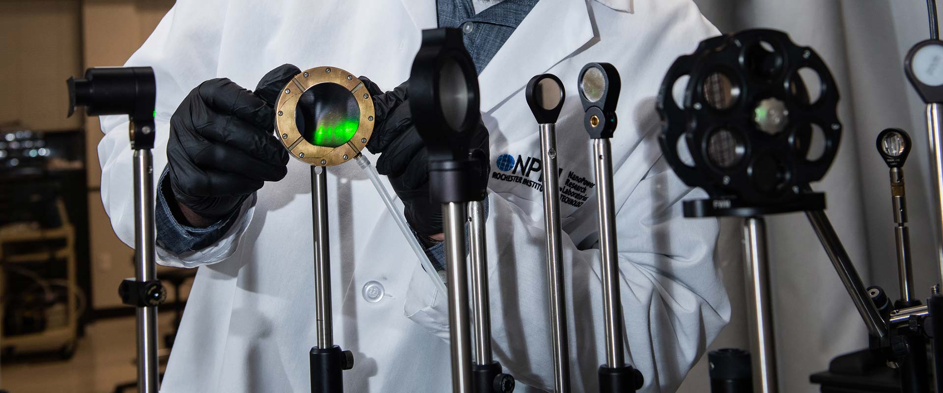 A researcher adjusting lenses and sensors as part of an experiment.