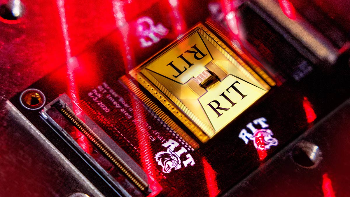 a circuit board chip with the R I T logo engraved on it.