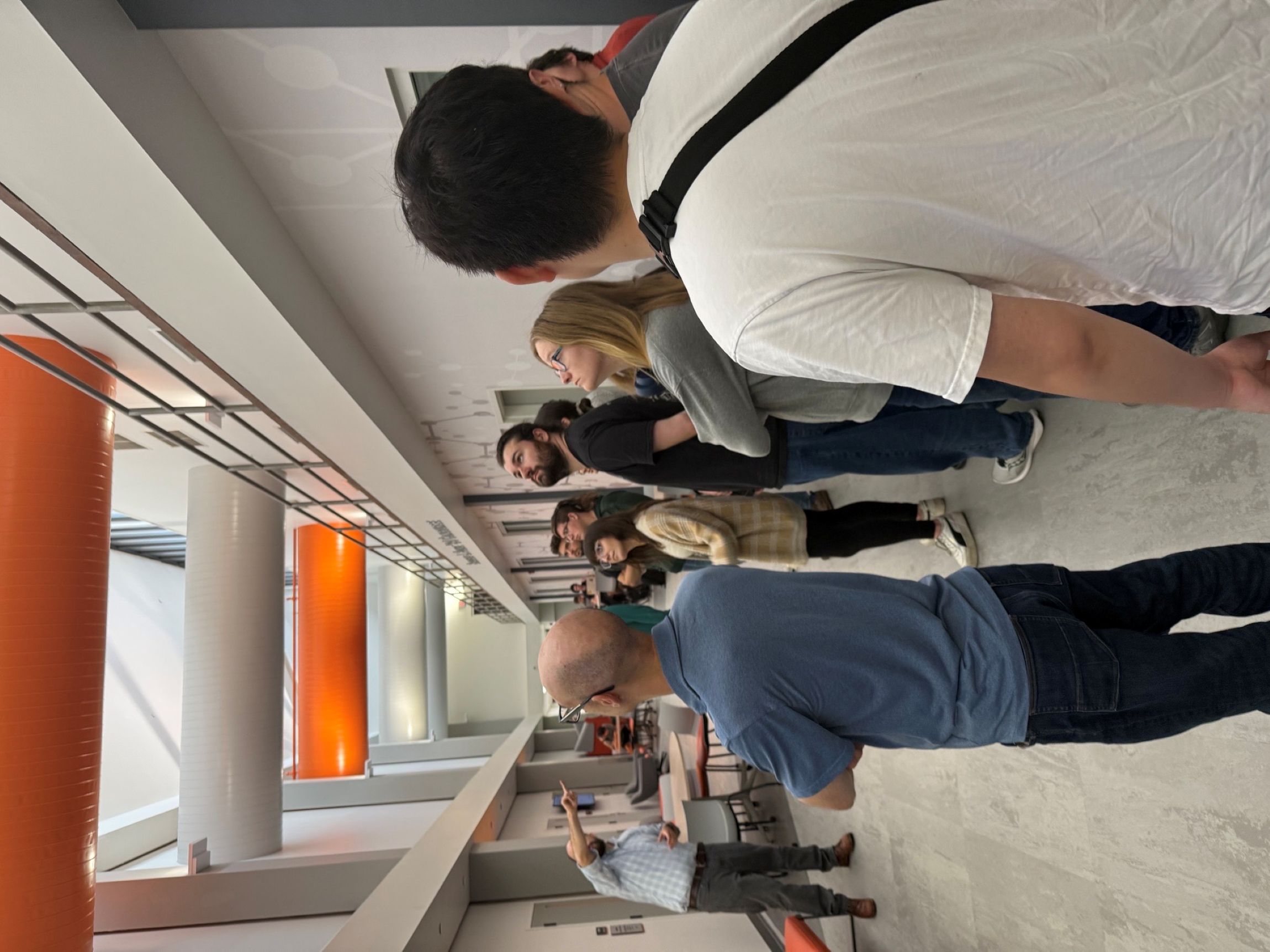 Professor explaining SNL lab and cleanroom tubes above ceiling