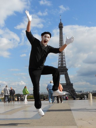 JJ Jones, a mime, leaps into the air in front of the Eiffel Tower in Paris, France.