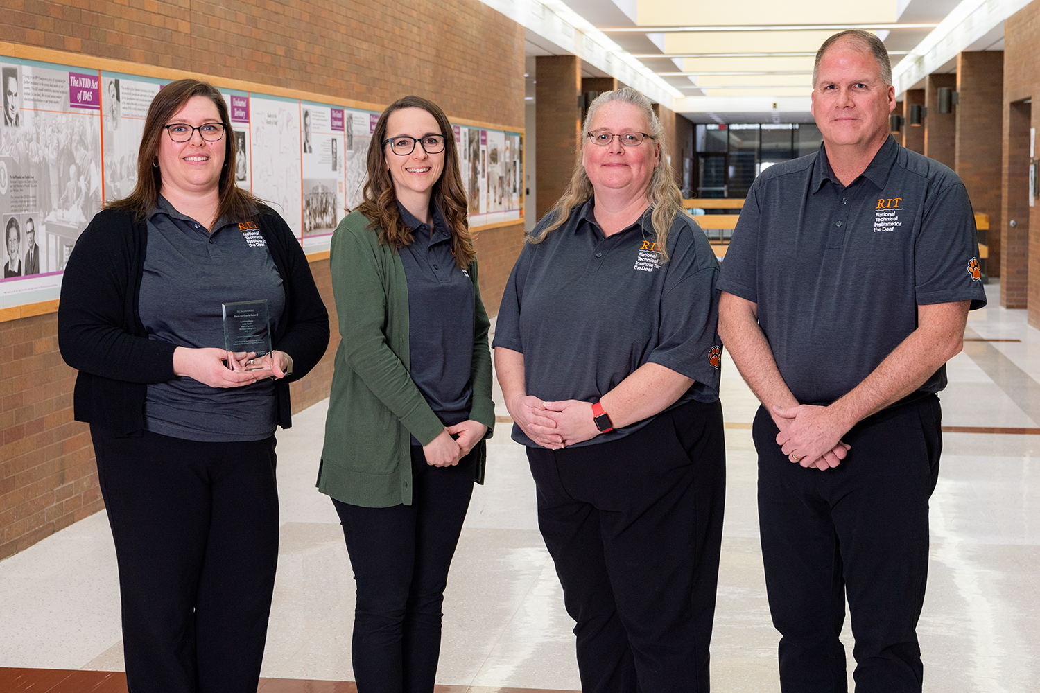 Photo of 4 people standing: Kathleen Brady, Kelly Metz-Davis, Mellissa Youngman and Mark Pfuntner