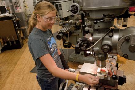 A camper works with equipment in a lab