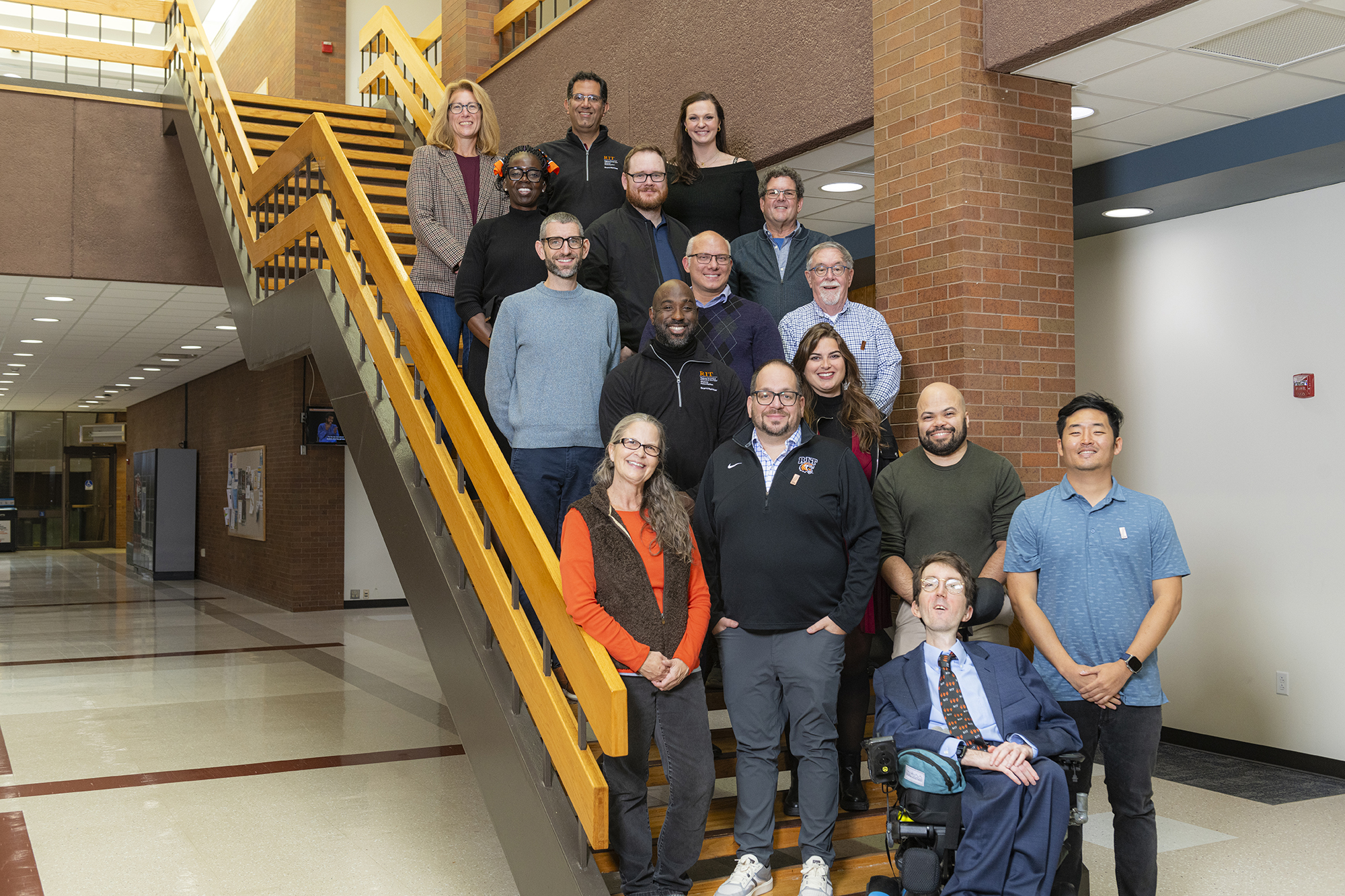 Alumni Board group photo standing on/near stairs.