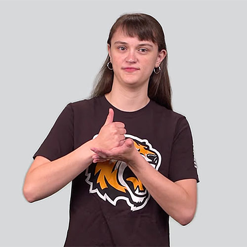 Person demonstrating the American Sign Language sign for 'help' with a neutral background. The person is wearing a black t-shirt with a tiger logo.