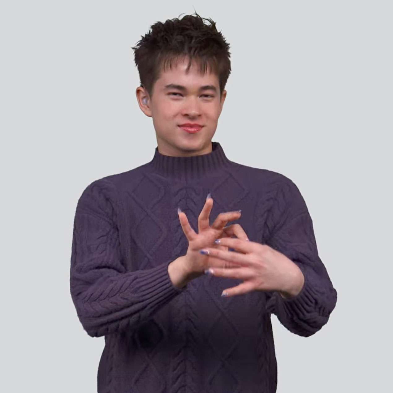 Person in a dark cable-knit sweater, signing 'connect'.