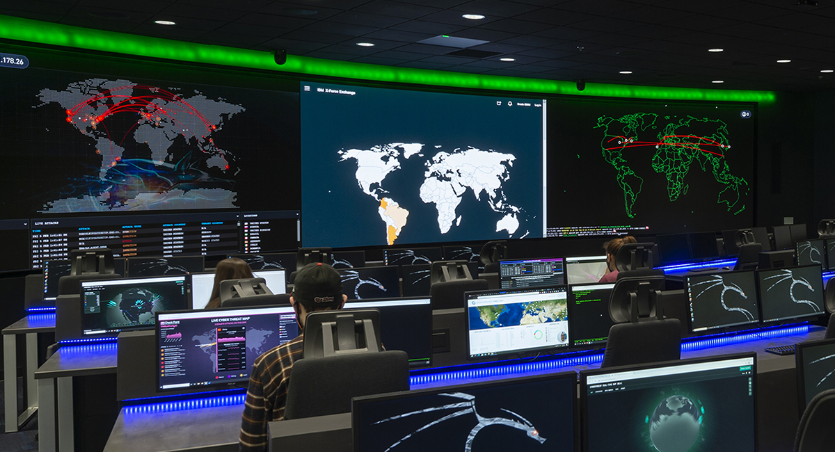 Photo of cybersecurity room with monitoring equipment and displays