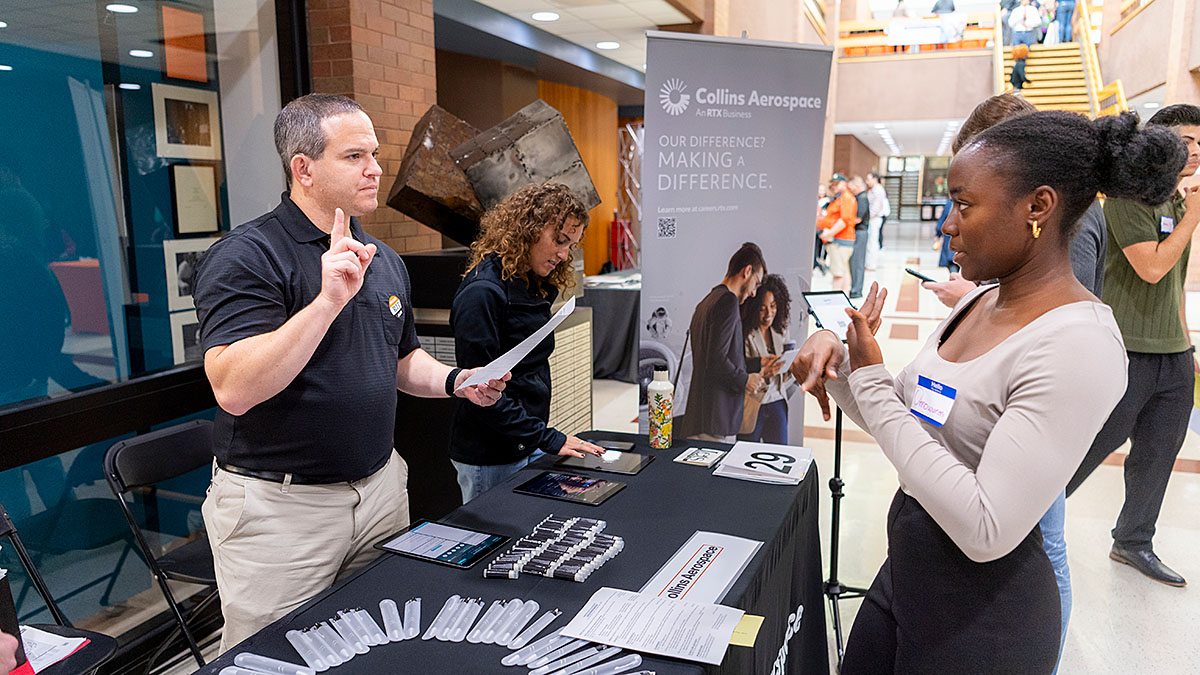 Student speaks with an employer at the career fair