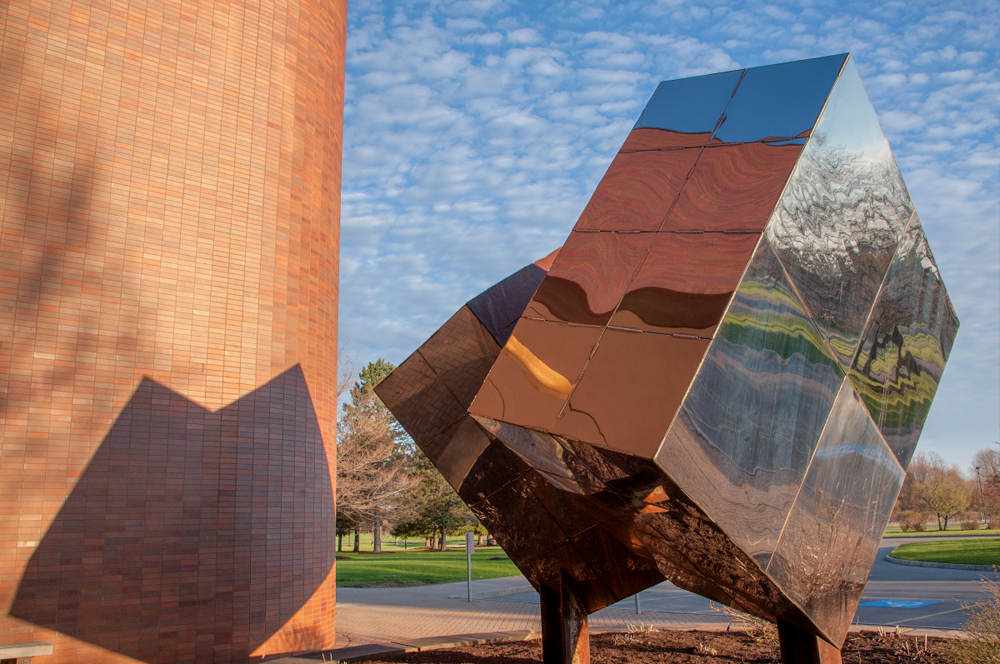 Photo of cube sculpture in front of the Lyndon Baines Johnson building at RIT/NTID